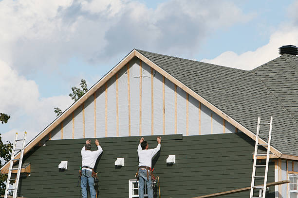 Professional Storm Damage Siding Repair technician working in Bellevue, OH